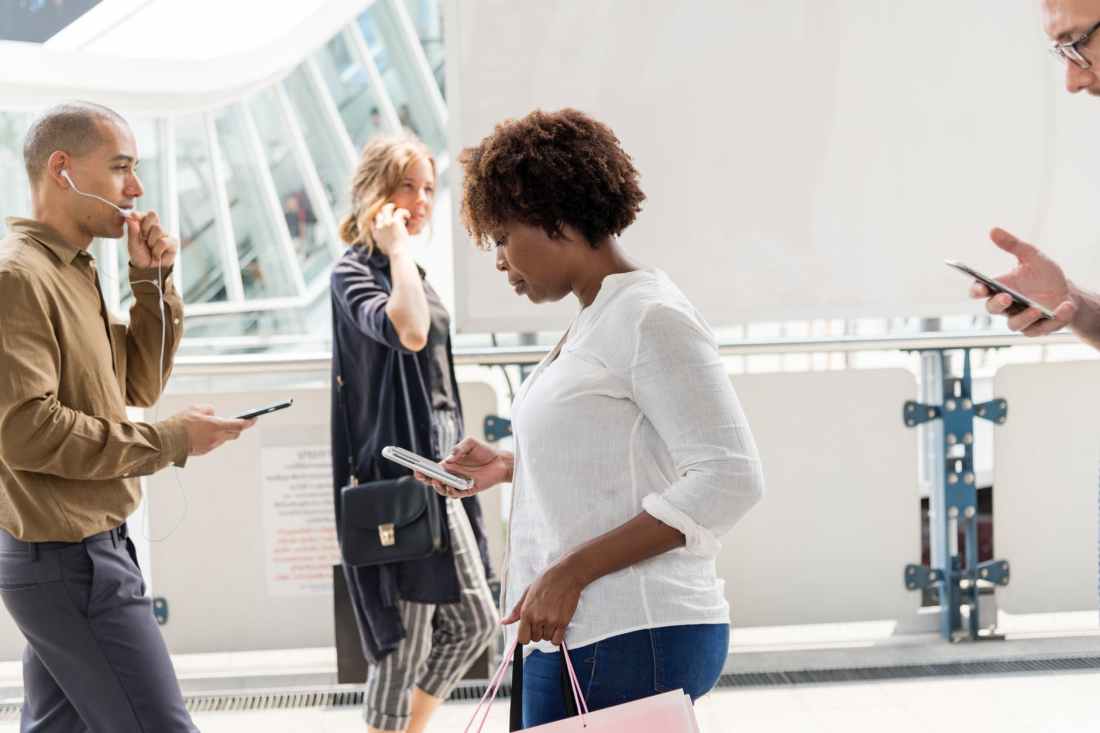 people walking while using their gadgets