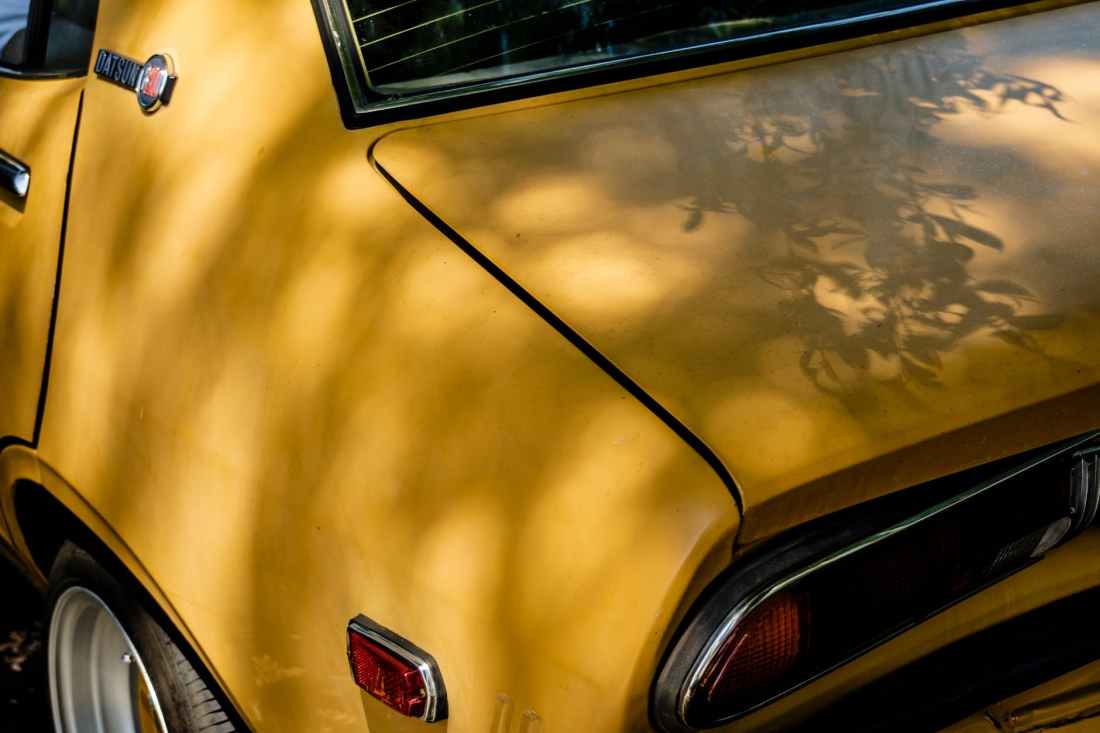 yellow classic datsun car
