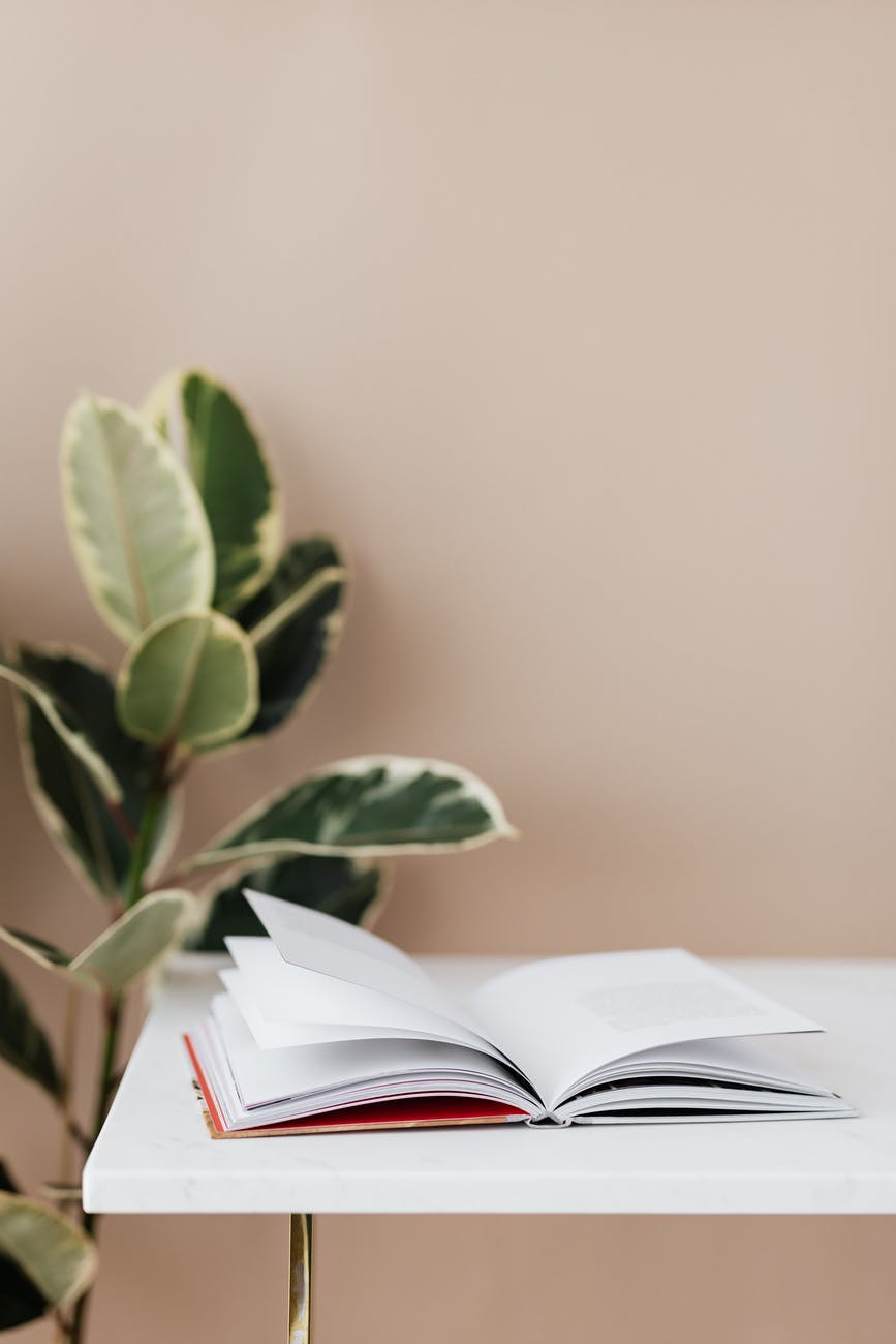 open book on white table in library